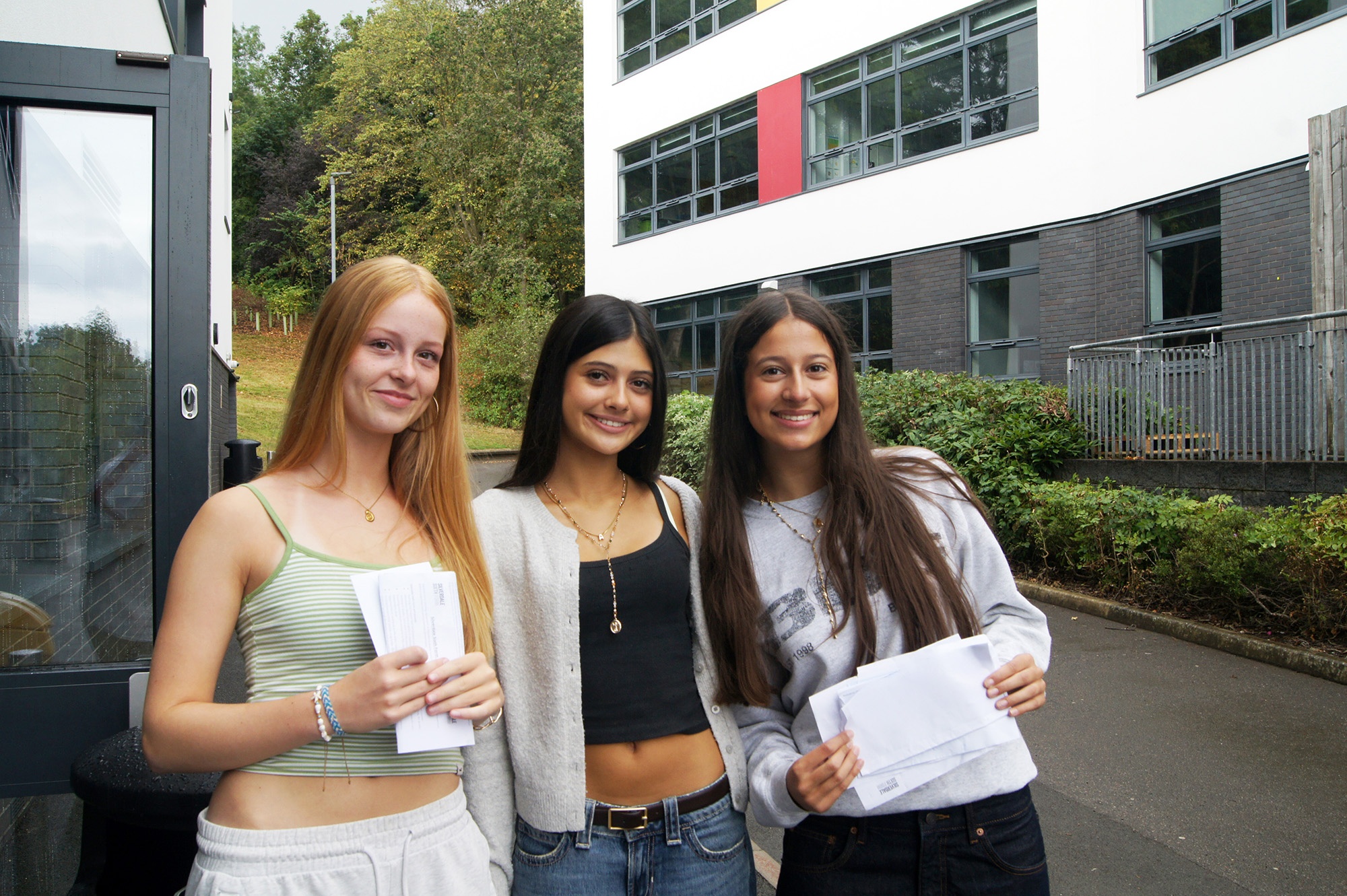 Three Silverdale students celebrating their GCSE results