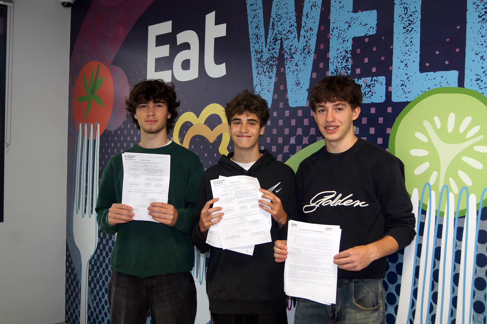 Three Silverdale students smiling and celebrating their results